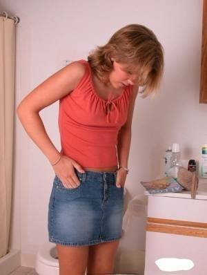 Amateur girl Karen hikes her denim skirt in the bathroom to expose her panties on leaks.pics