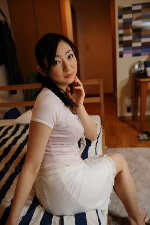 Slender mature Japanese woman Emiko Koike bends over to pose in white dress - Japan on leaks.pics