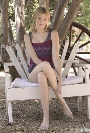 Teen first timer Lena Anderson vaunts her lithe body under a tree outside on leaks.pics
